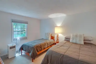 a white bedroom with a bed and a window at Water-View Home in the Berkshires in Sheffield