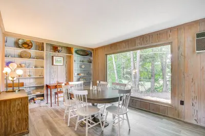 a dining room with a table and chairs and a window at Water-View Home in the Berkshires in Sheffield
