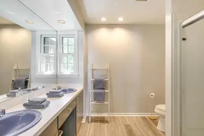 a bathroom with two sinks and a toilet at Water-View Home in the Berkshires in Sheffield