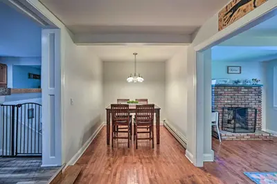 a dining room with a table and chairs and a fireplace at Pet-Friendly Saratoga Springs Home with Pool! in Saratoga Springs