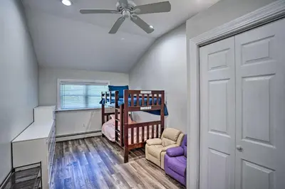 a room with a crib and a ceiling fan at Pet-Friendly Saratoga Springs Home with Pool! in Saratoga Springs