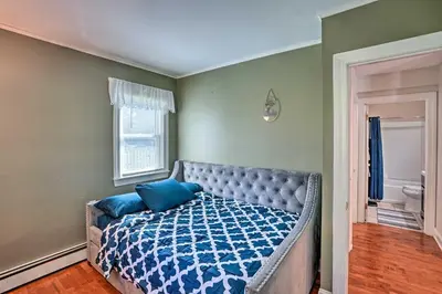 a bedroom with a bed with blue pillows on it at Pet-Friendly Saratoga Springs Home with Pool! in Saratoga Springs