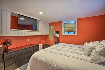 a bedroom with orange walls and a bed in it at Pet-Friendly Saratoga Springs Home with Pool! in Saratoga Springs