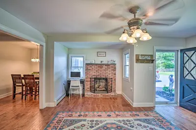 a living room with a fireplace and a dining room at Pet-Friendly Saratoga Springs Home with Pool! in Saratoga Springs
