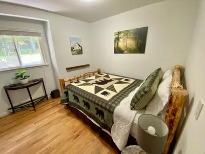 a bedroom with a bed with a quilt on it at Escape to a 3-Bedroom Cabin in Lower Catskills in Woodridge