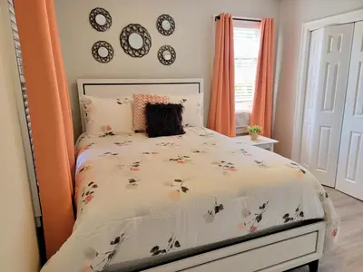 a bedroom with a bed with a floral comforter at 1 Bedroom apartment in Hartford
