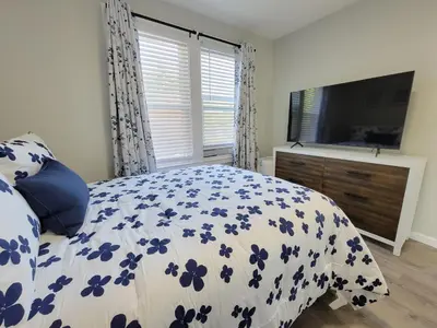 a bedroom with a bed with a blue and white comforter at 1 Bedroom apartment in Hartford