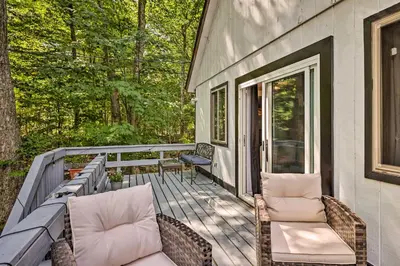 a porch with two chairs and a couch on it at Chic Tobyhanna Home with Furnished Deck Space! in Tobyhanna