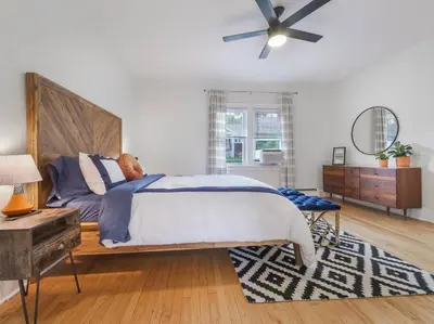 a bedroom with a bed and a ceiling fan at MidCentury Mod Suite, Hudson River/Mt Beacon Views in Newburgh