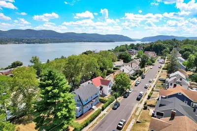 an aerial view of a small town with a lake at MidCentury Mod Suite, Hudson River/Mt Beacon Views in Newburgh
