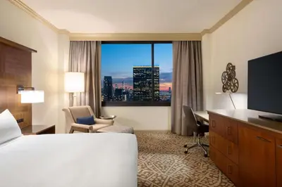 a hotel room with a bed and a large window at Hilton New York Times Square in New York