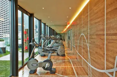 a row of exercise bikes in a gym at citizenM New York Times Square in New York