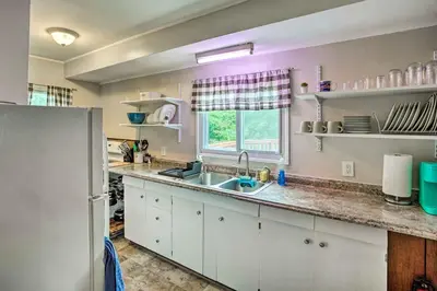 a kitchen with white cabinets and a sink and a window at Secluded Getaway Less Than 10 Mi to Saratoga Springs! in South Corinth
