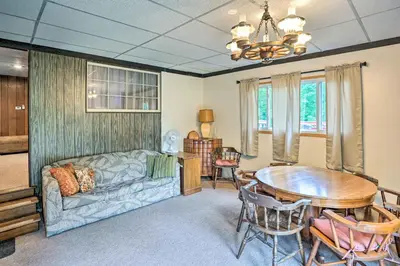 a living room with a couch and a table at Secluded Getaway Less Than 10 Mi to Saratoga Springs! in South Corinth