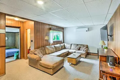 a living room with a couch and a television at Secluded Getaway Less Than 10 Mi to Saratoga Springs! in South Corinth