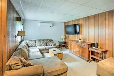 a living room with a couch and a flat screen tv at Secluded Getaway Less Than 10 Mi to Saratoga Springs! in South Corinth