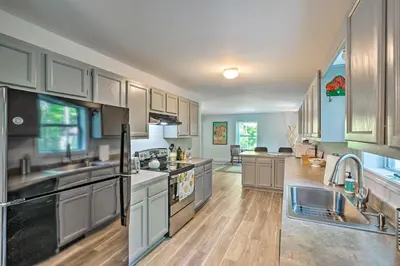 a large kitchen with stainless steel appliances and wooden floors at Peaceful Athens Retreat at Sleepy Hollow Lake in Athens