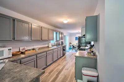a kitchen with green cabinets and a counter top at Peaceful Athens Retreat at Sleepy Hollow Lake in Athens