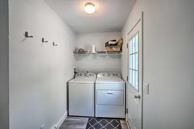 a white laundry room with a washer and dryer at Peaceful Athens Retreat at Sleepy Hollow Lake in Athens