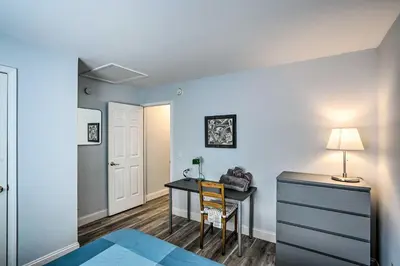 a bedroom with a desk and a table with a chair at Peaceful Athens Retreat at Sleepy Hollow Lake in Athens