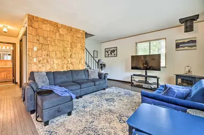 a living room with a couch and a tv at Walk to Lake Game Room Getaway in Pocono Summit! in Pocono Summit