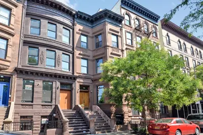 a building with a red car parked in front of it at Home NYC in New York