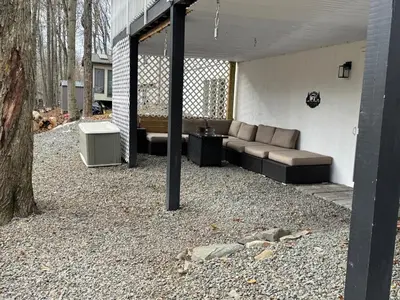 a patio with a couch and a table and a tree at Casa Rosado @ Pocono II by Lake Hot Tub Camelback in Tobyhanna