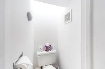 a bathroom with a toilet with a box of tissues at Hoot Owl Hollow in Jacksonville