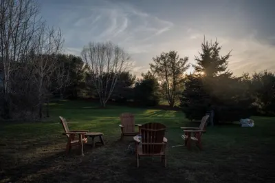 a group of chairs and tables in the grass at Hotel Vienna in Windham