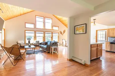a living room with a couch and a table at Beautiful mountain home with gorgeous meadow views in Hunter