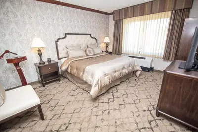 a bedroom with a large bed and a television at Best Western Plus Fairfield Executive Inn in Fairfield