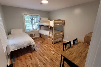 a bedroom with a bunk bed and a table at Large Vacation Home Villa- Pool, Indoor Hotub, Game Room, up to 25 guests in Monticello