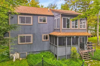 a gray house with windows and a roof at The Cabin in Pocono Summit