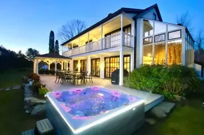 a large house with a hot tub in front of it at The Manor-Stunning Modern Farmhouse with Hot Tub in Dover