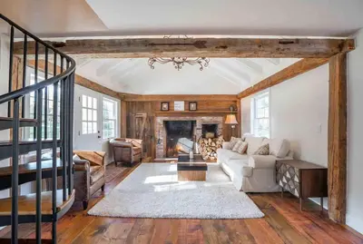 a living room with a couch and a fireplace at The Villa - Industrial Farmhouse with Hot Tub in Dover