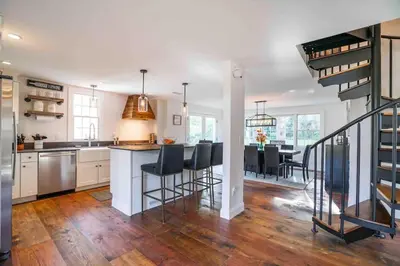 a kitchen and dining room with a kitchen and a dining table at The Villa - Industrial Farmhouse with Hot Tub in Dover