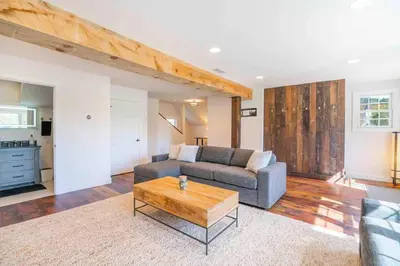 a living room with a couch and a coffee table at The Villa - Industrial Farmhouse with Hot Tub in Dover