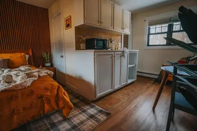 a kitchen with a bed and a refrigerator in a room at The Willow, Catskill in Catskill