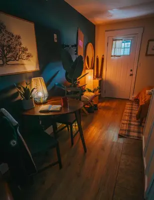 a living room with a table with a lamp and a plant at The Willow, Catskill in Catskill