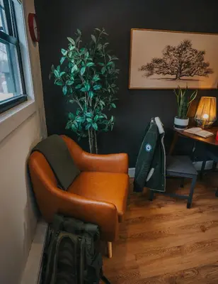 a living room with a chair and a table at The Willow, Catskill in Catskill