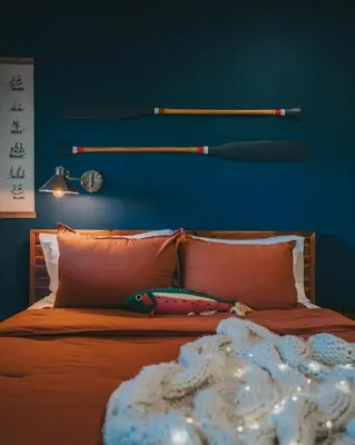 a bed with a baseball bat on a blue wall at The Willow, Catskill in Catskill