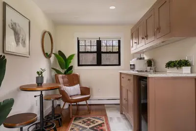 a kitchen with a counter and a table and chairs at The Willow, Catskill in Catskill