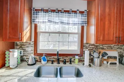 a kitchen counter with a sink and a window at Woodstock Getaway with Hot Tub about 2 Mi to Dtwn! in Woodstock