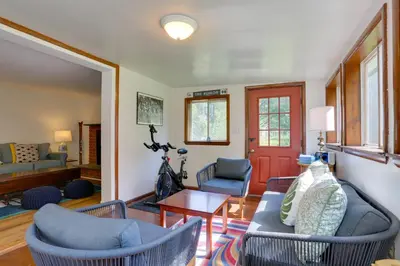 a living room with blue chairs and a red door at Woodstock Getaway with Hot Tub about 2 Mi to Dtwn! in Woodstock