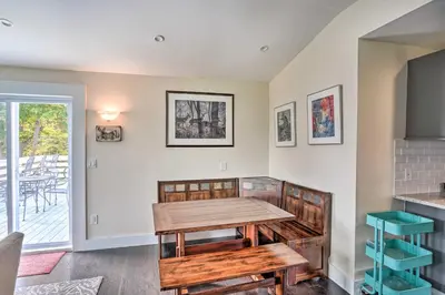 a dining room with a wooden table and a balcony at Jewett Gem with Charcoal Grill and Mountain Views in Jewett