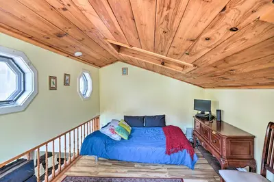 a bedroom with a bed and a wooden ceiling at Jewett Gem with Charcoal Grill and Mountain Views in Jewett