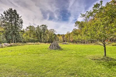 a field with a pile of grass and a tree at Jewett Gem with Charcoal Grill and Mountain Views in Jewett