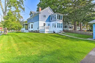 a blue and white house with a large yard at Cozy and Walkable Delmar Getaway with Fire Pit! in Delmar