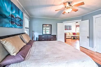 a bedroom with a bed and a ceiling fan at Cozy and Walkable Delmar Getaway with Fire Pit! in Delmar