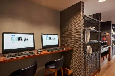 a desk with two monitors and a computer on it at Hampton Inn Manhattan/Downtown- Financial District in New York